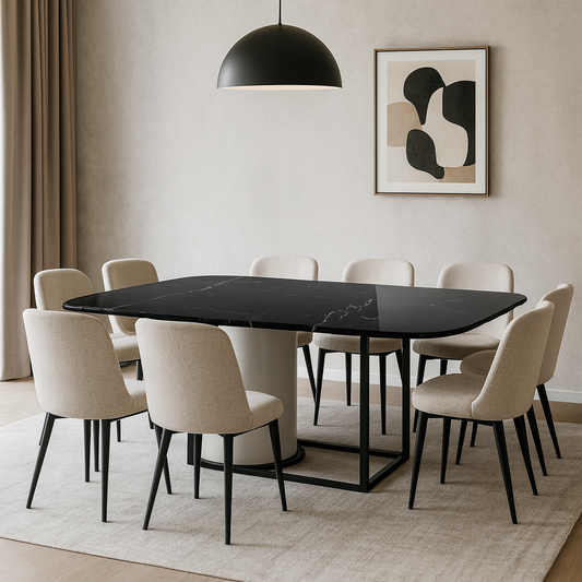 Dining room with a black marble table and beige chairs, featuring abstract art on the wall.